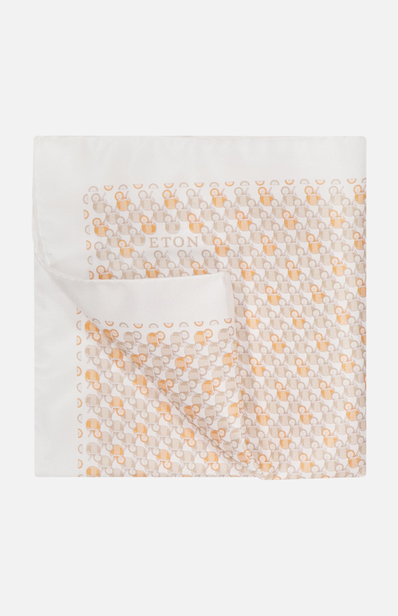 The ETON Cocktail Silk Twill Pocket Square is a white luxury accessory with orange, light gray, and beige geometric patterns and a folded corner. "ETON" appears subtly in the center. Made in Italy.