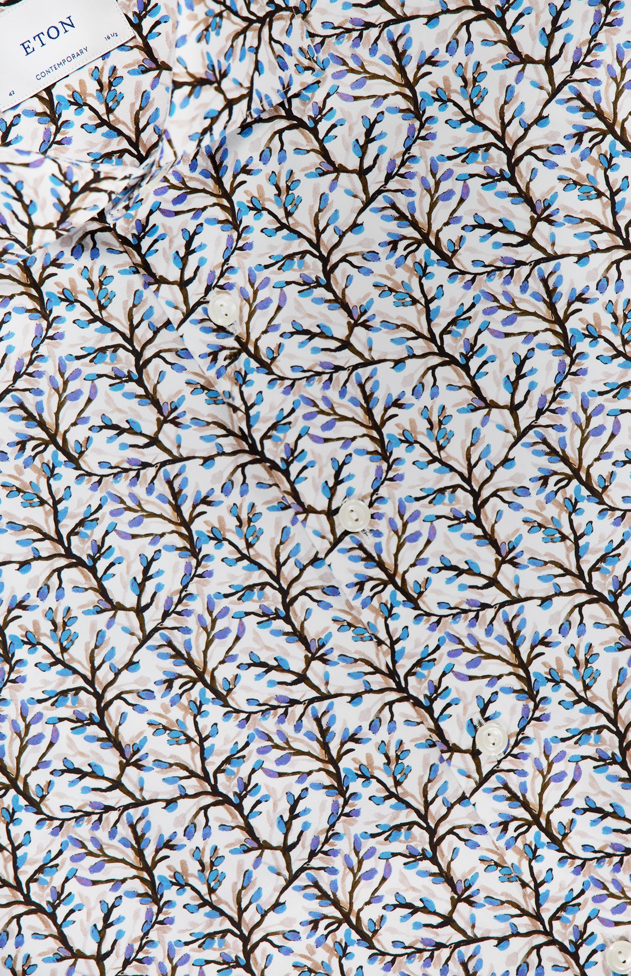 The ETON Floral Print Contemporary Dress Shirt features 100% cotton fabric with brown branches and small blue leaves on white, plus a visible ETON label in the upper left—ideal for a modern blue floral look.