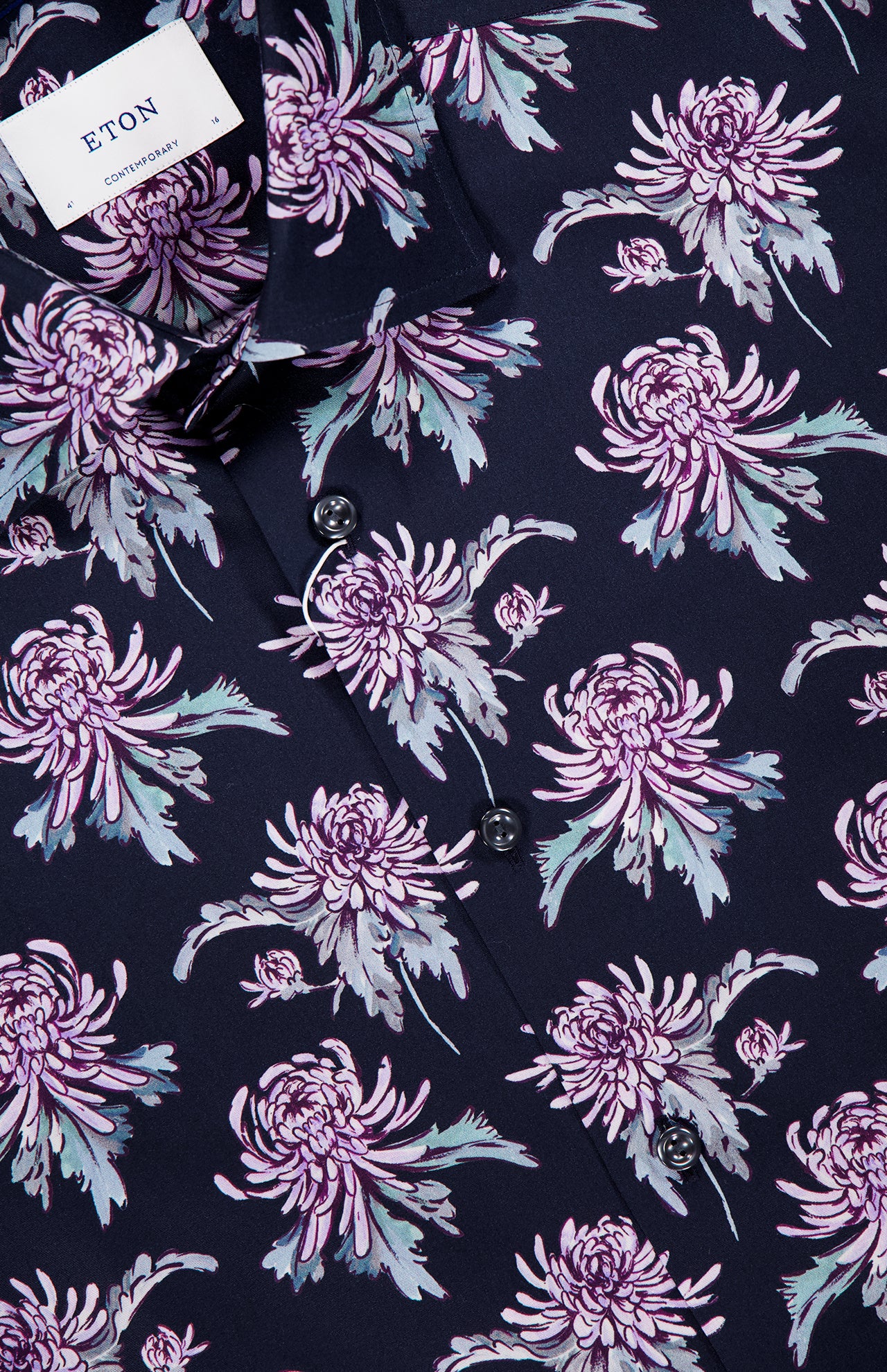 Close-up of the ETON Floral Print Twill Contemporary Dress Shirt in dark navy, showcasing a multicolored floral print with large lavender and purple chrysanthemums, greenish-gray leaves, black buttons, and a visible collar with the ETON label.