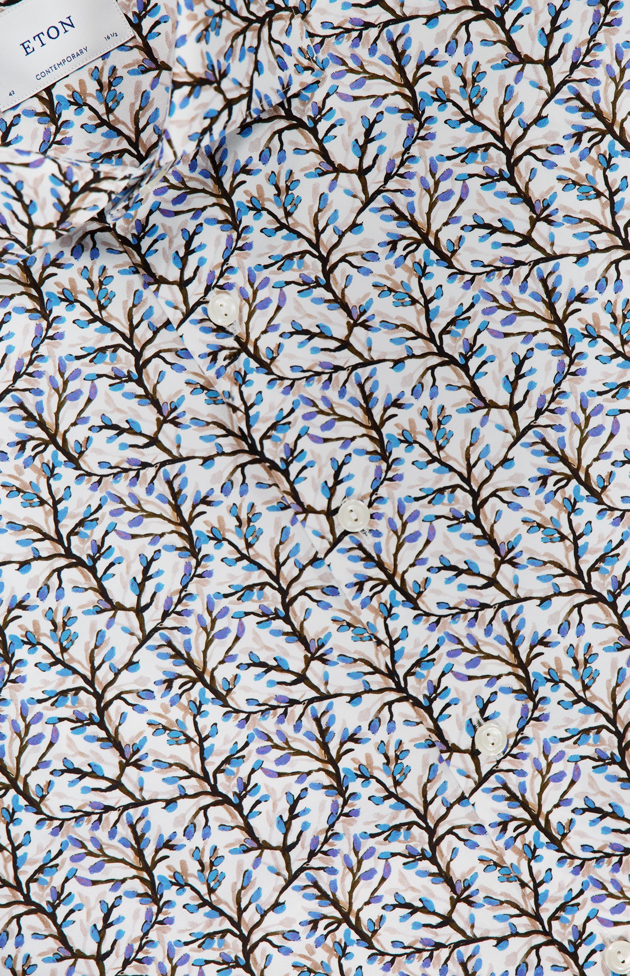 Close-up of the ETON Floral Print Slim Dress Shirt, showcasing a patterned white fabric with brown branches and blue leaves. A label at the top left displays the ETON brand.