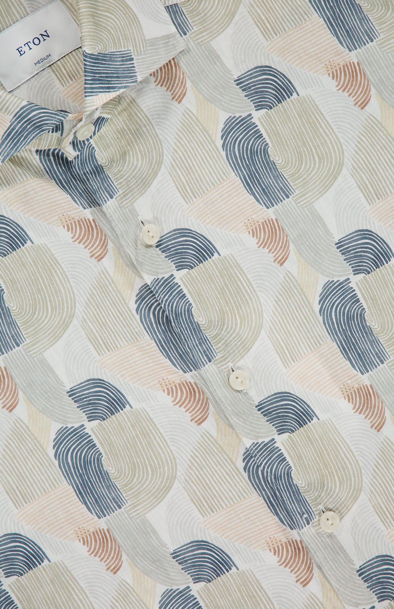 Close-up of the ETON Geometric Print Linen Dress Shirt featuring a repeating abstract pattern in blue, beige, tan, and gray with white buttons—an ideal shirt for special occasions.