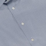 Close-up of ETON's Geometric Signature Twill Dress Shirt in blue, slim fit with a subtle geometric pattern, white buttons, visible collar, and CONTEMPORARY tag. Wrinkle-resistant for lasting style.