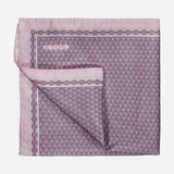 Introducing the ETON Geometric Silk Twill Pocket Square—a folded pink silk accessory adorned with an intricate geometric pattern in purple and blue, complete with a solid pink border and a subtly turned-up corner revealing the reverse side of the fabric. This elegant luxury piece is perfect for elevating sophisticated ensembles.