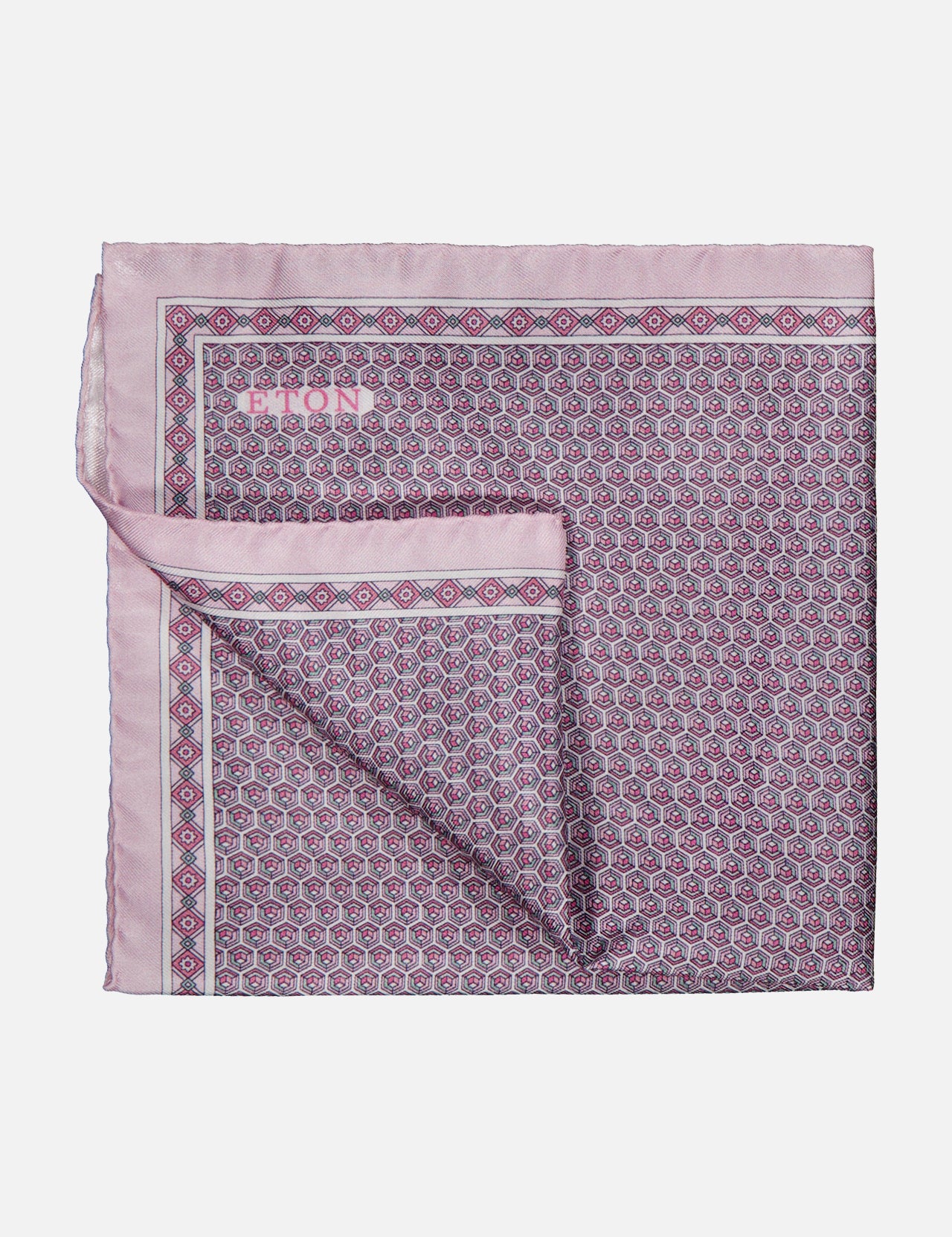 Introducing the ETON Geometric Silk Twill Pocket Square—a folded pink silk accessory adorned with an intricate geometric pattern in purple and blue, complete with a solid pink border and a subtly turned-up corner revealing the reverse side of the fabric. This elegant luxury piece is perfect for elevating sophisticated ensembles.