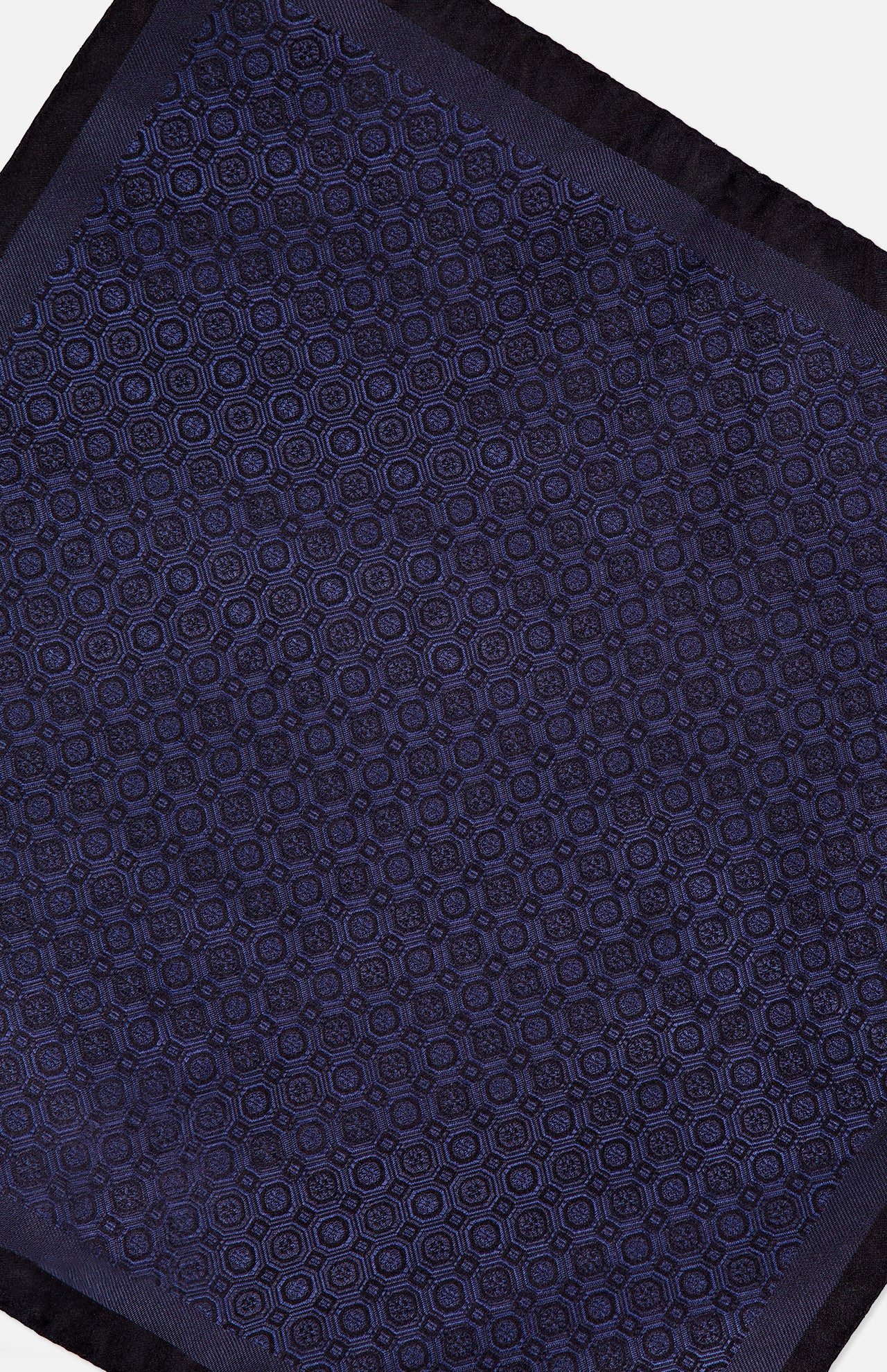 A close-up view of the ETON Medallion Woven Silk Pocket Square, featuring an intricate circular geometric pattern in dark blue with a solid navy border—making it a truly luxurious accessory.