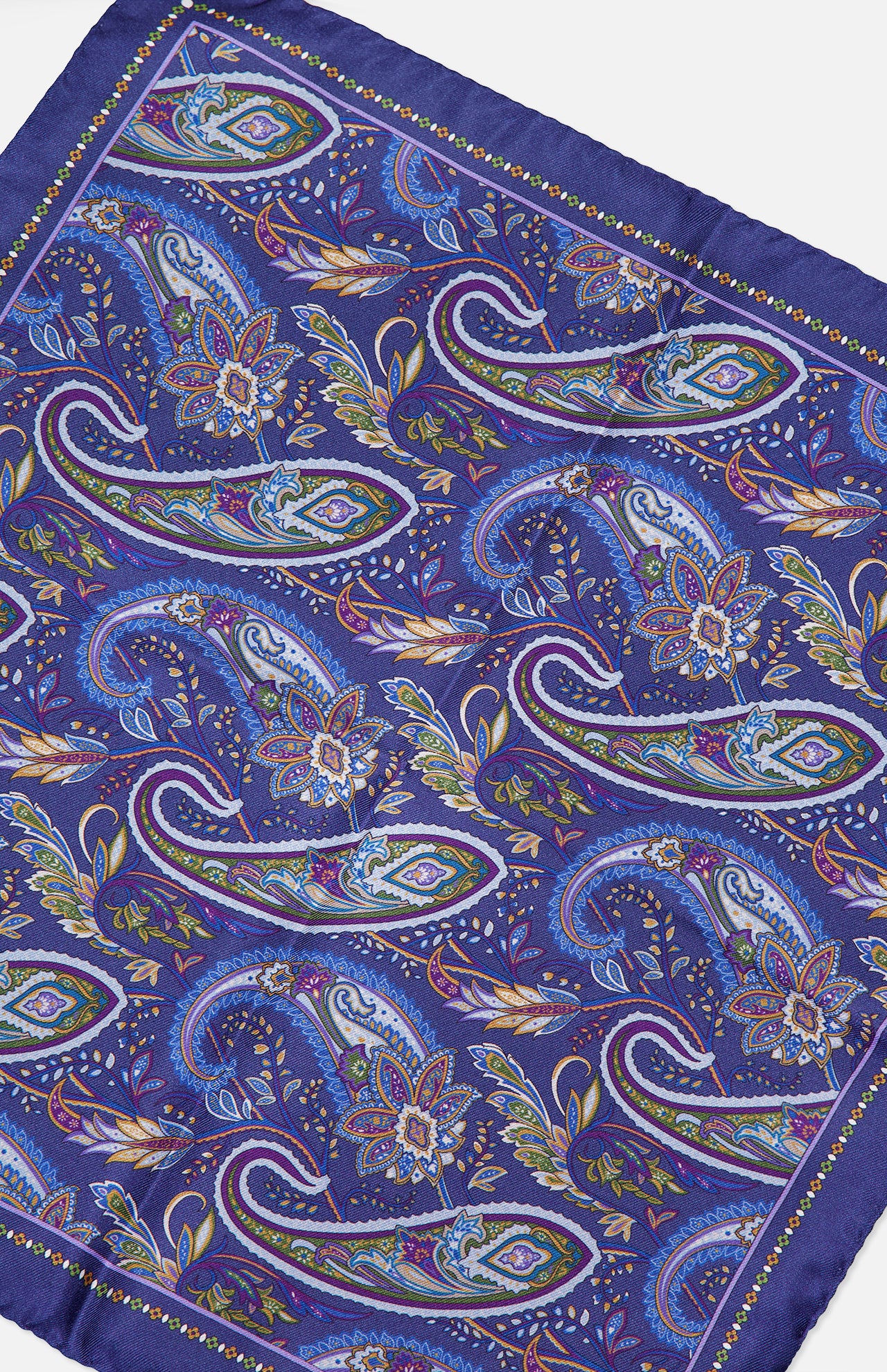 The ETON Paisley Silk Twill Pocket Square showcases a luxurious blue background enhanced by a vibrant paisley pattern in shades of blue, green, purple, and yellow, finished with a solid blue border. This striking accessory is perfect for adding an elegant touch to any ensemble.