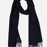 The ETON Patchwork Merino Wool Scarf, in a rich dark navy hue, features a textured pattern and unique patchwork design accents. Loosely folded into a loop and finished with fringe tassels on each end, this cozy wool scarf is displayed against a plain light background.