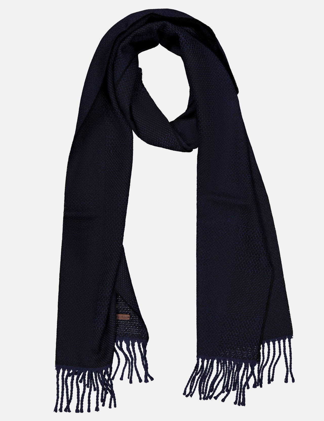 The ETON Patchwork Merino Wool Scarf, in a rich dark navy hue, features a textured pattern and unique patchwork design accents. Loosely folded into a loop and finished with fringe tassels on each end, this cozy wool scarf is displayed against a plain light background.
