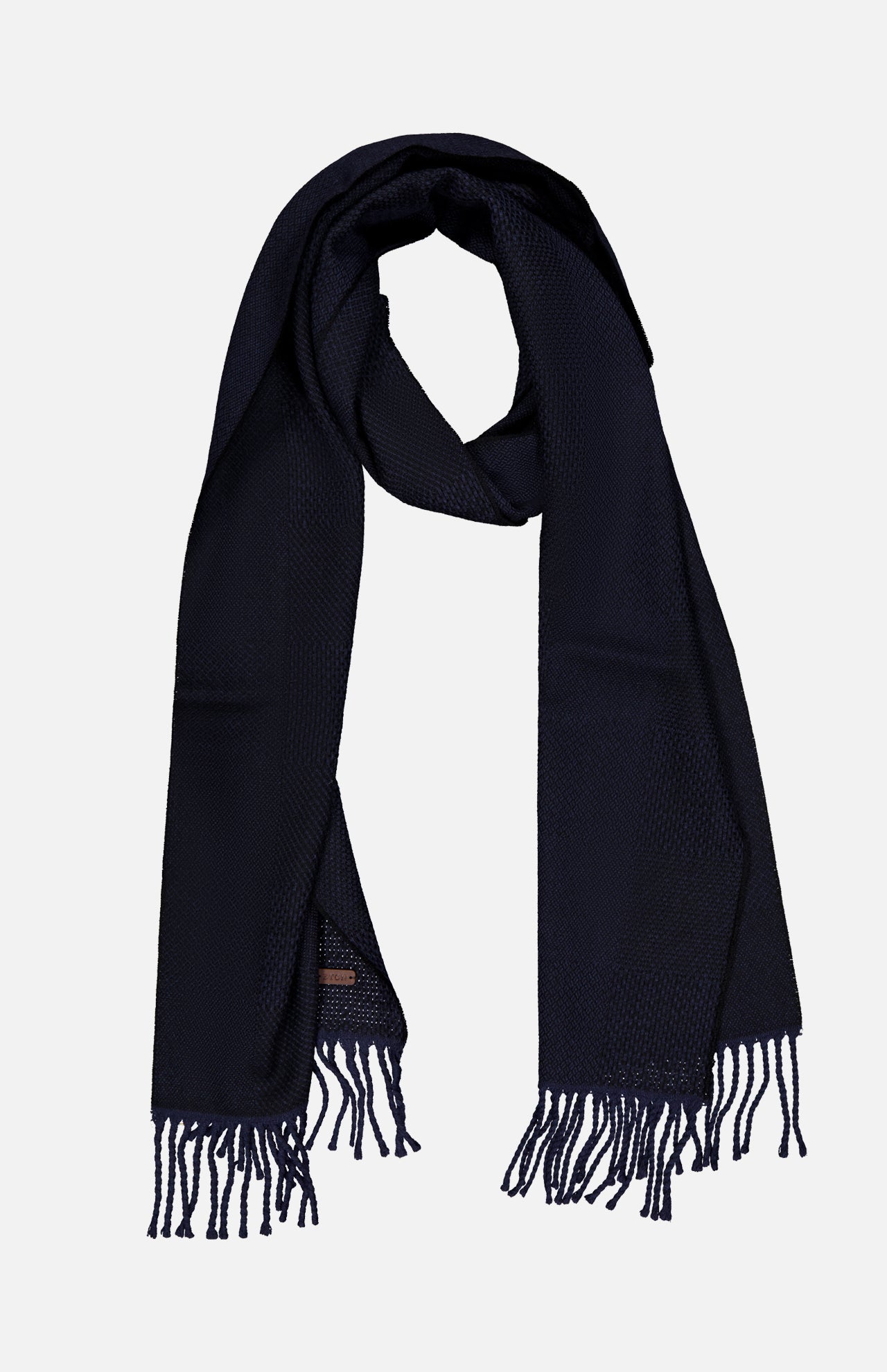 The ETON Patchwork Merino Wool Scarf, in a rich dark navy hue, features a textured pattern and unique patchwork design accents. Loosely folded into a loop and finished with fringe tassels on each end, this cozy wool scarf is displayed against a plain light background.