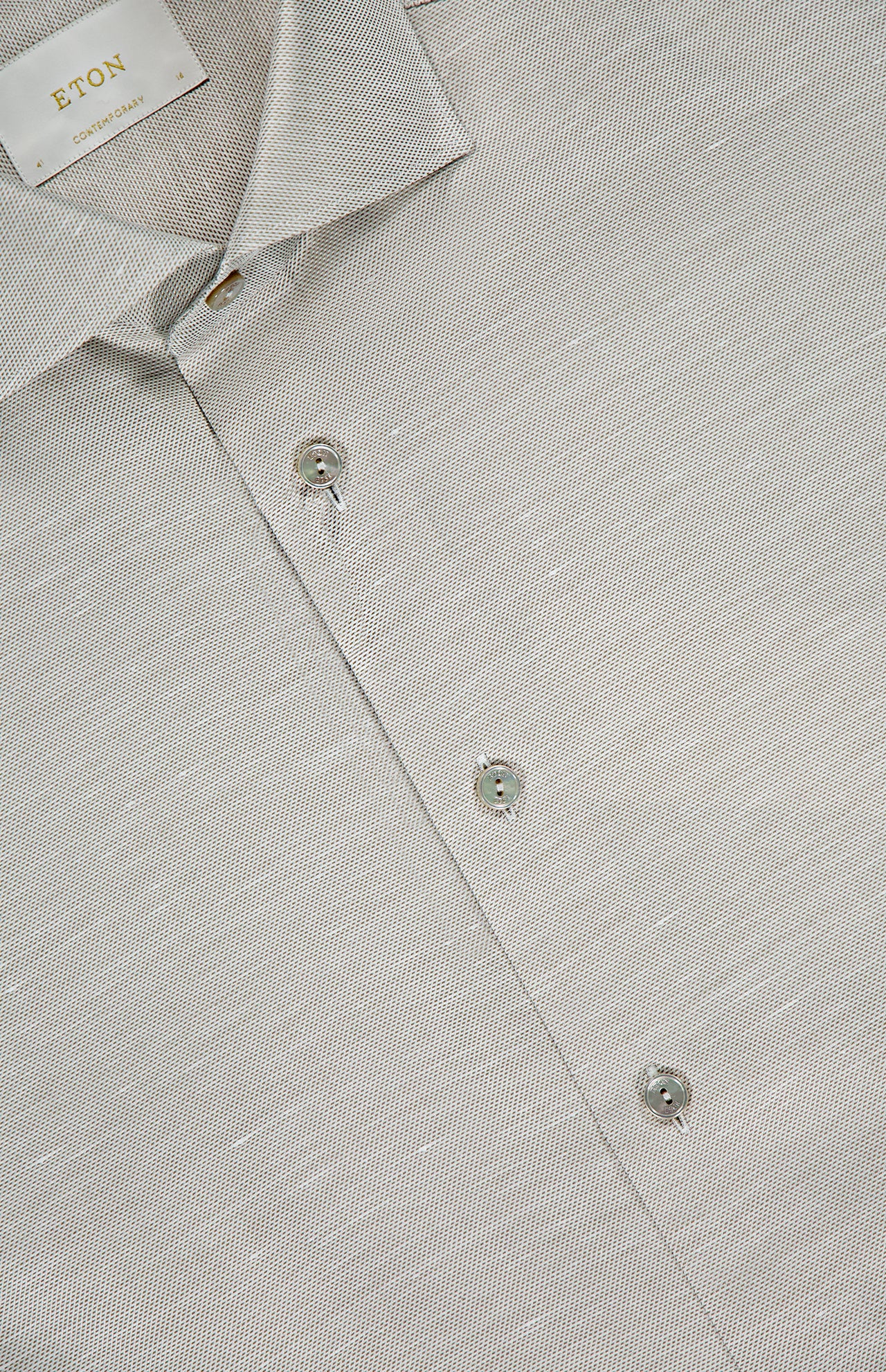 Close-up of a light gray Semi Solid Cotton Linen Dress Shirt by ETON featuring a pointed collar, three visible buttons, and an ETON label—ideal for formal occasions.