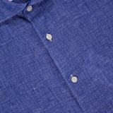 Close-up of a blue Solid Linen Dress Shirt by ETON, featuring white buttons and an inner collar label displaying ETON and MEDIUM—ideal for men’s summer wear.