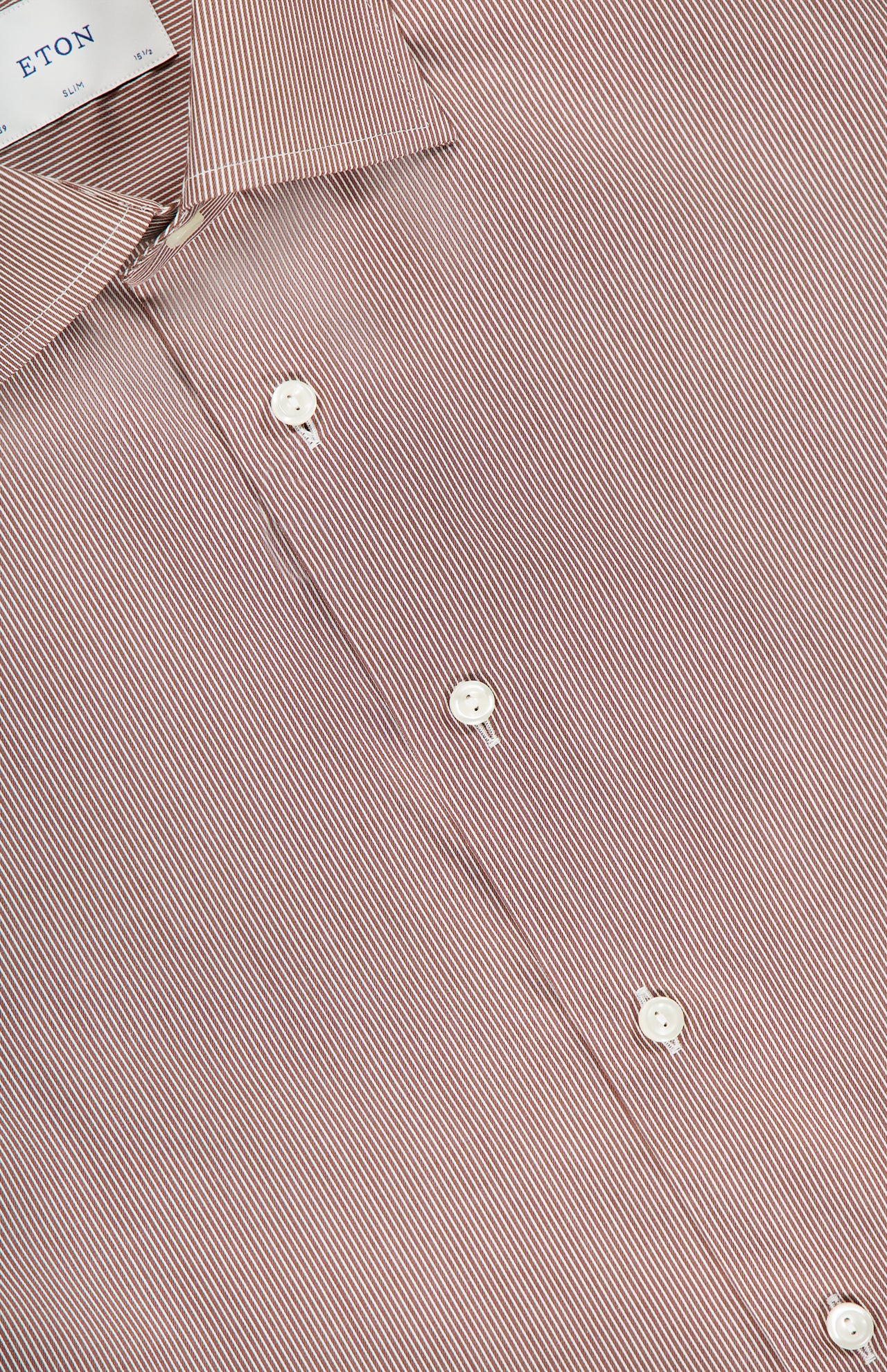 A close-up of the ETON Striped Fine Twill Slim Dress Shirt highlights its brown stripes, white buttons, visible ETON collar tag, slim fit, and wrinkle-resistant fabric.