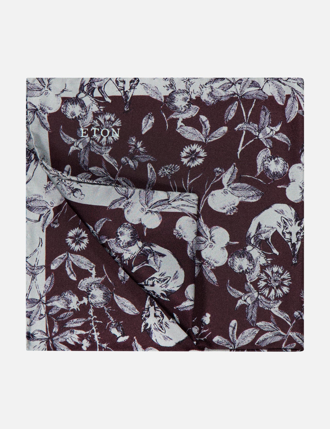 ETON’s Seasonal Silk Pocket Square, made in Italy, features a burgundy background with a white floral and fruit woodland print.