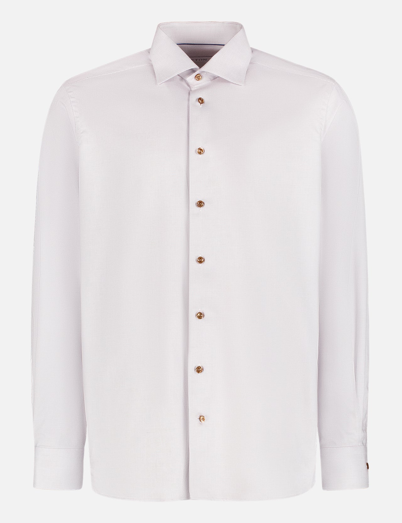 The ETON Semi Solid Cotton Tencel Lyocell Shirt is a long-sleeved, white dress shirt with a classic collar, brown buttons, and a modern fit, showcased on a plain white background.