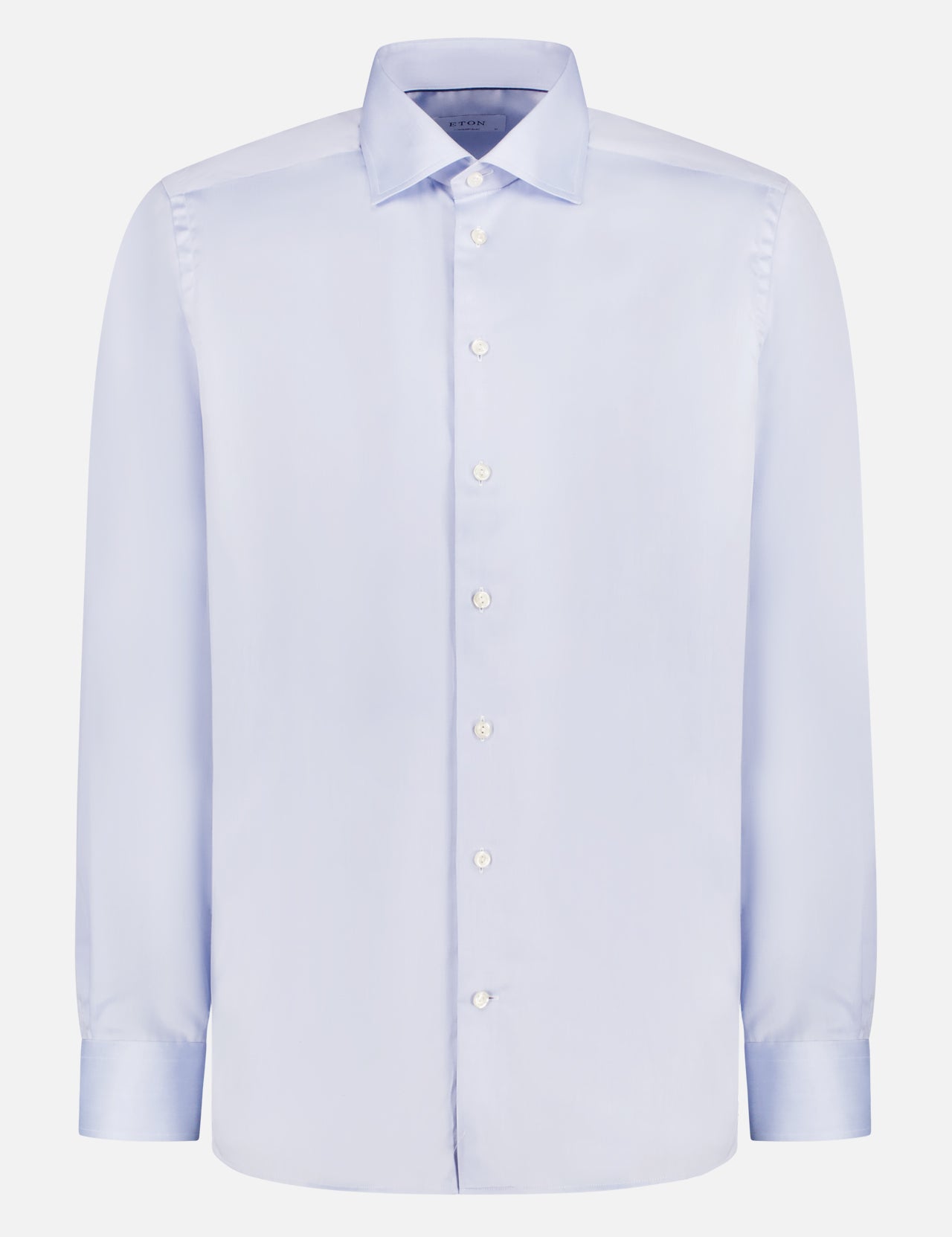 The ETON Signature Twill Shirt is a light blue, long-sleeve, 100% cotton dress shirt with a classic collar, white buttons, and buttoned cuffs. Shown on a plain white background, it offers a smooth, wrinkle-free appearance.