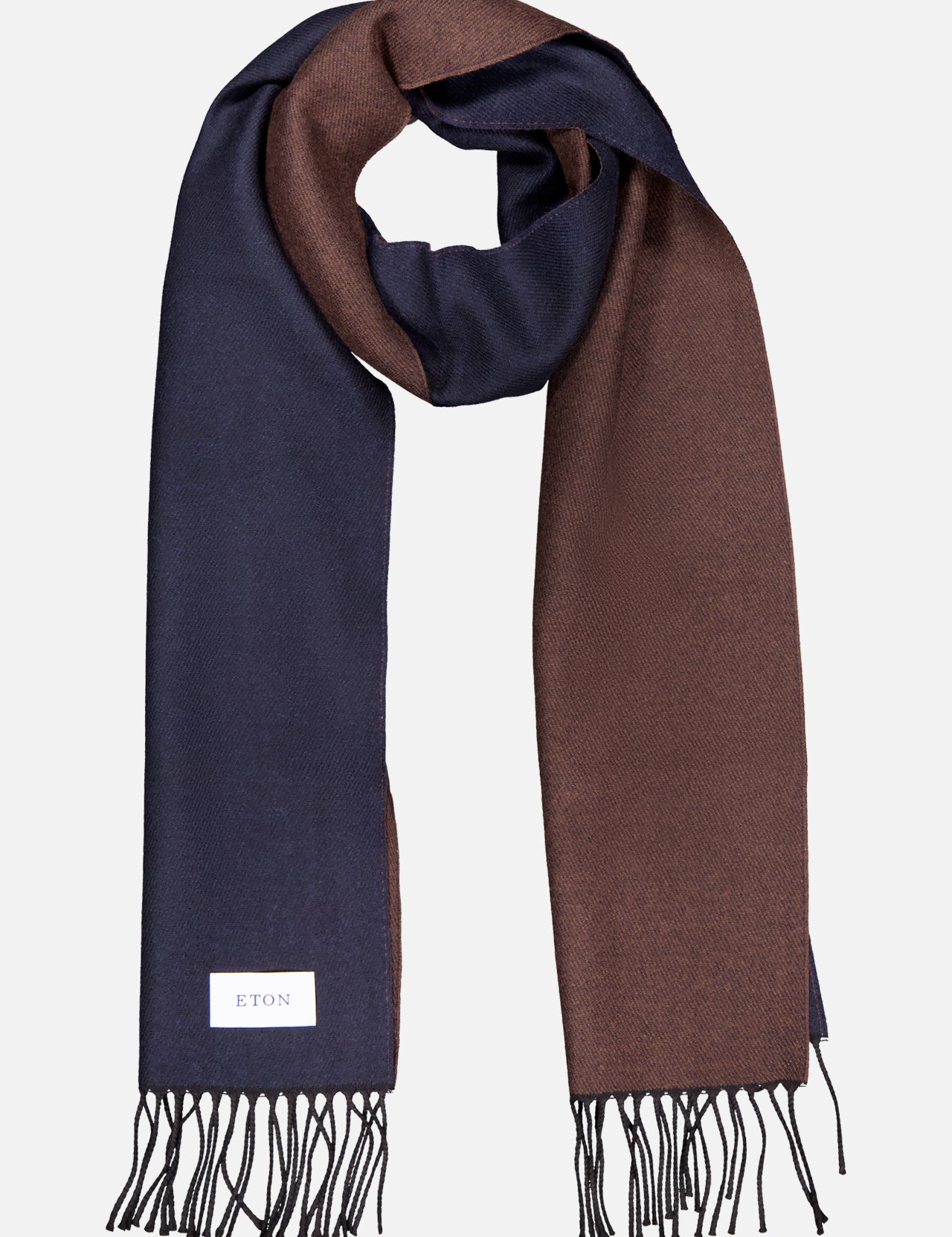 The ETON Two-Sided Merino Wool Scarf features navy blue on one side and brown on the other, finished with fringed ends and a white ETON label, crafted in Italy and presented on a light background.