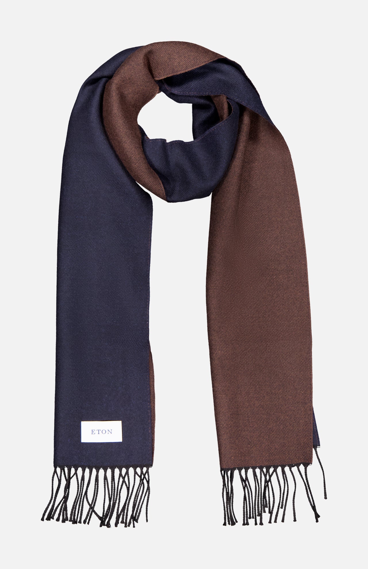 The ETON Two-Sided Merino Wool Scarf features navy blue on one side and brown on the other, finished with fringed ends and a white ETON label, crafted in Italy and presented on a light background.