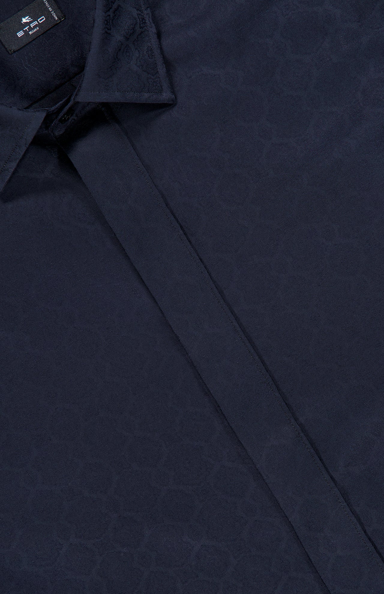 Close-up of the ETRO Jacquard Long Sleeve Dress Shirt in navy, crafted from soft cotton and featuring a subtle geometric jacquard pattern, with the collar and partially visible placket on display.