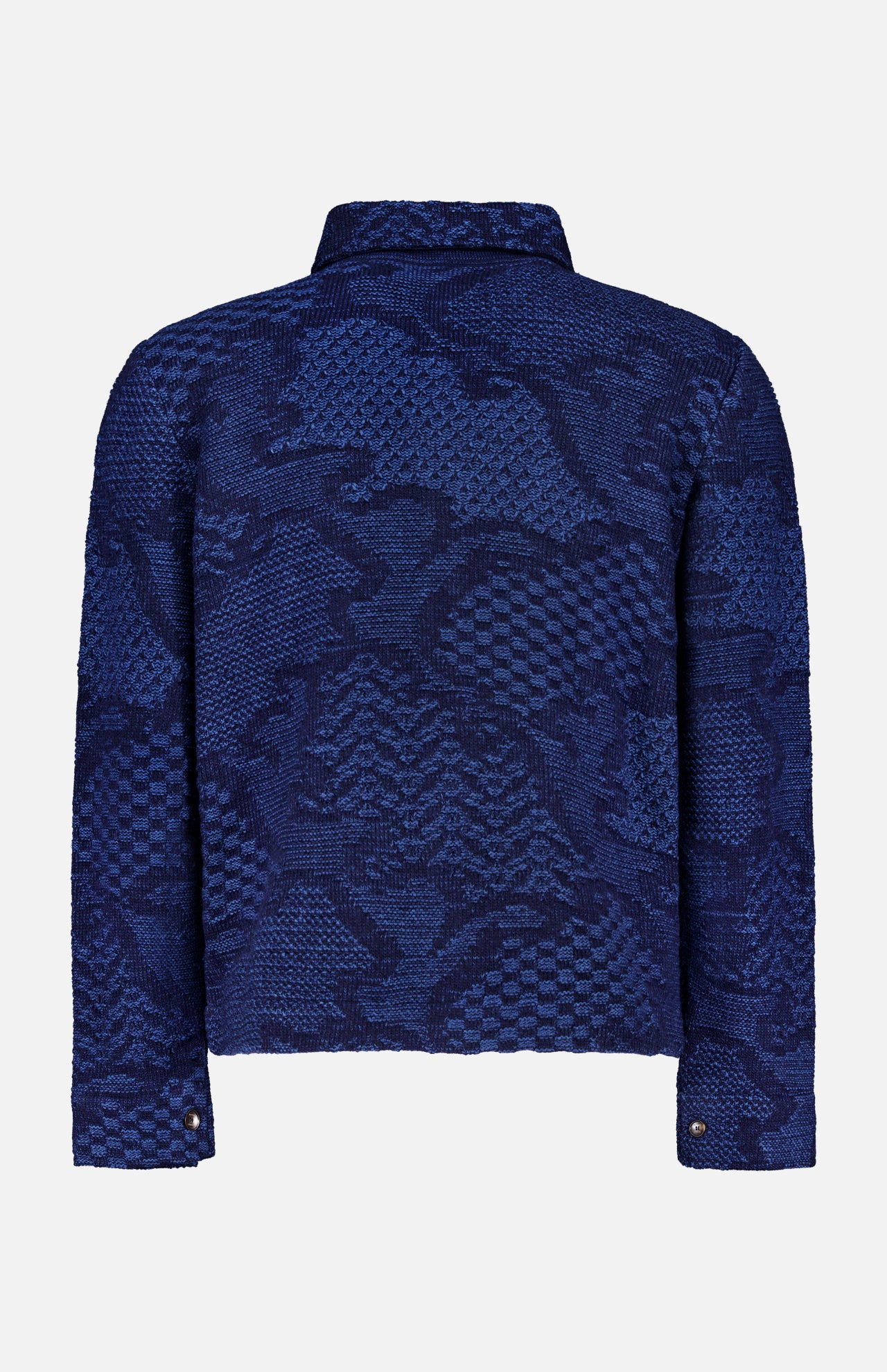 The ETRO Knitted Pattern Jacket, crafted in Italy, showcases a textured blue geometric design. This navy jacket features long sleeves, a collar, and snap button cuffs, and is displayed from the back against a plain background.