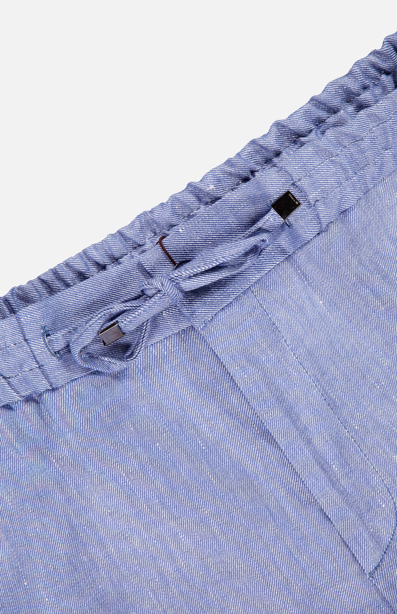 Close-up of the waistband on ETRO’s Linen Drawstring Trouser Pants, featuring a drawstring and elastic band. Made from lightweight, striped linen-blend fabric, these pants offer comfort and style for casual wear.