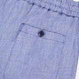 Close-up of ETRO Linen Drawstring Trouser Pants in light blue, showcasing a textured elastic waistband, single stitched back pocket with dark button, and soft linen-blend fabric for casual comfort.