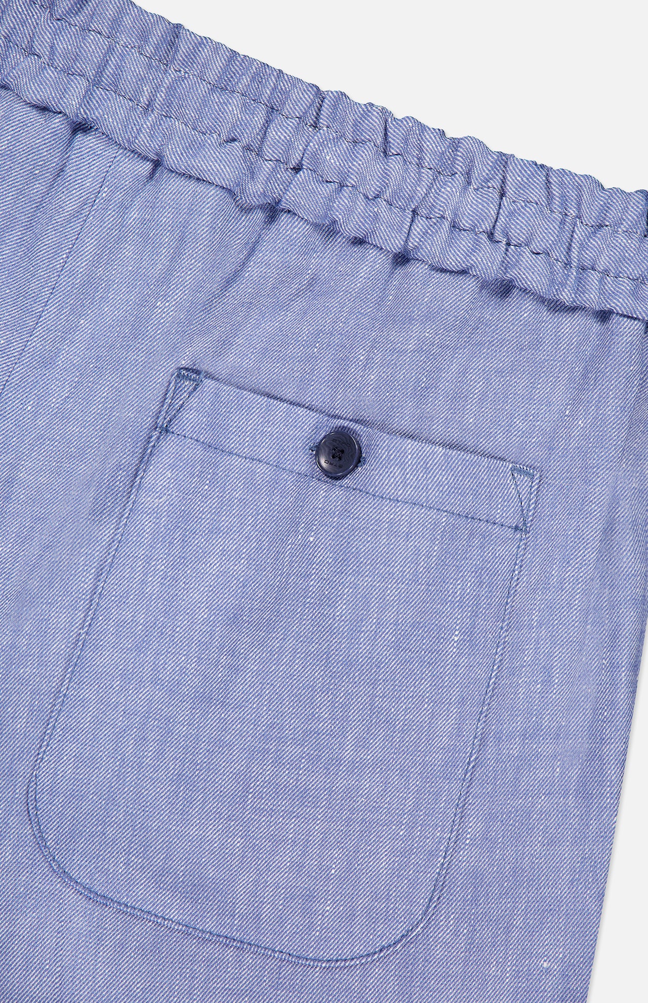 Close-up of ETRO Linen Drawstring Trouser Pants in light blue, showcasing a textured elastic waistband, single stitched back pocket with dark button, and soft linen-blend fabric for casual comfort.