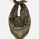 The ETRO Paisley Bandana Scarf is a brown silk accessory with gold paisley and geometric prints, knotted at the top and finished with a small white tag.