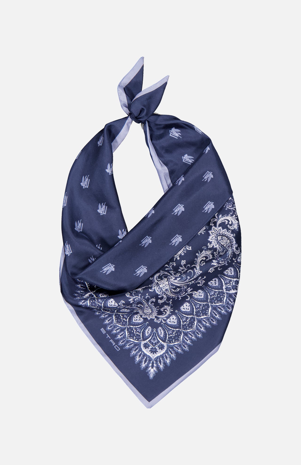 The ETRO Paisley Bandana Scarf in navy blue silk features white paisley and floral patterns, shown tied in a loose knot against a plain white background.