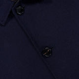Close-up of the ETRO Plaid Long Reversible Coat in navy wool, featuring three black buttons and part of the collar; a hint of plaid fabric peeks out from beneath the top collar, highlighting the refined detailing characteristic of this men’s Italian coat.