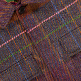 Close-up of the ETRO Plaid Wool-blend Overshirt, a perfect piece for fall fashion. This premium layering item features striking blue, green, pink, and orange plaid lines with visible buttons and pockets. The distinctive look is completed by a green floral inner lining that adds a unique touch to this versatile overshirt.