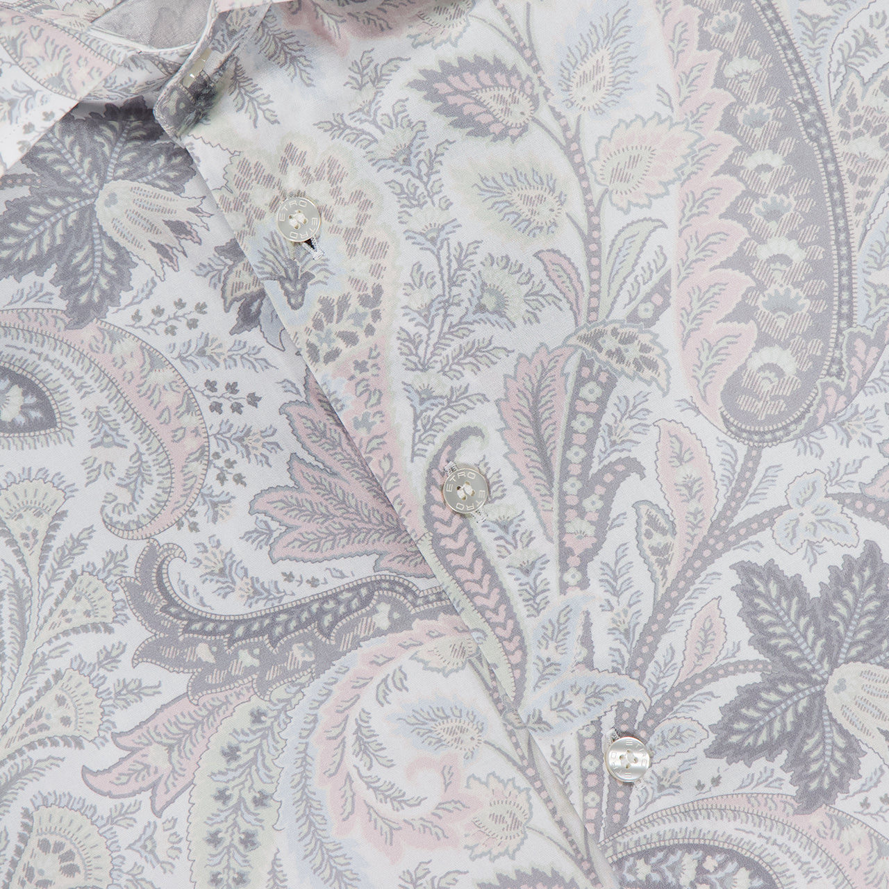 Close-up of ETRO's Paisley Long Sleeve Shirt, a men's cotton dress shirt with an intricate grey, pale pink, and lavender paisley print. The light grey collar and brand label are visible at the top.