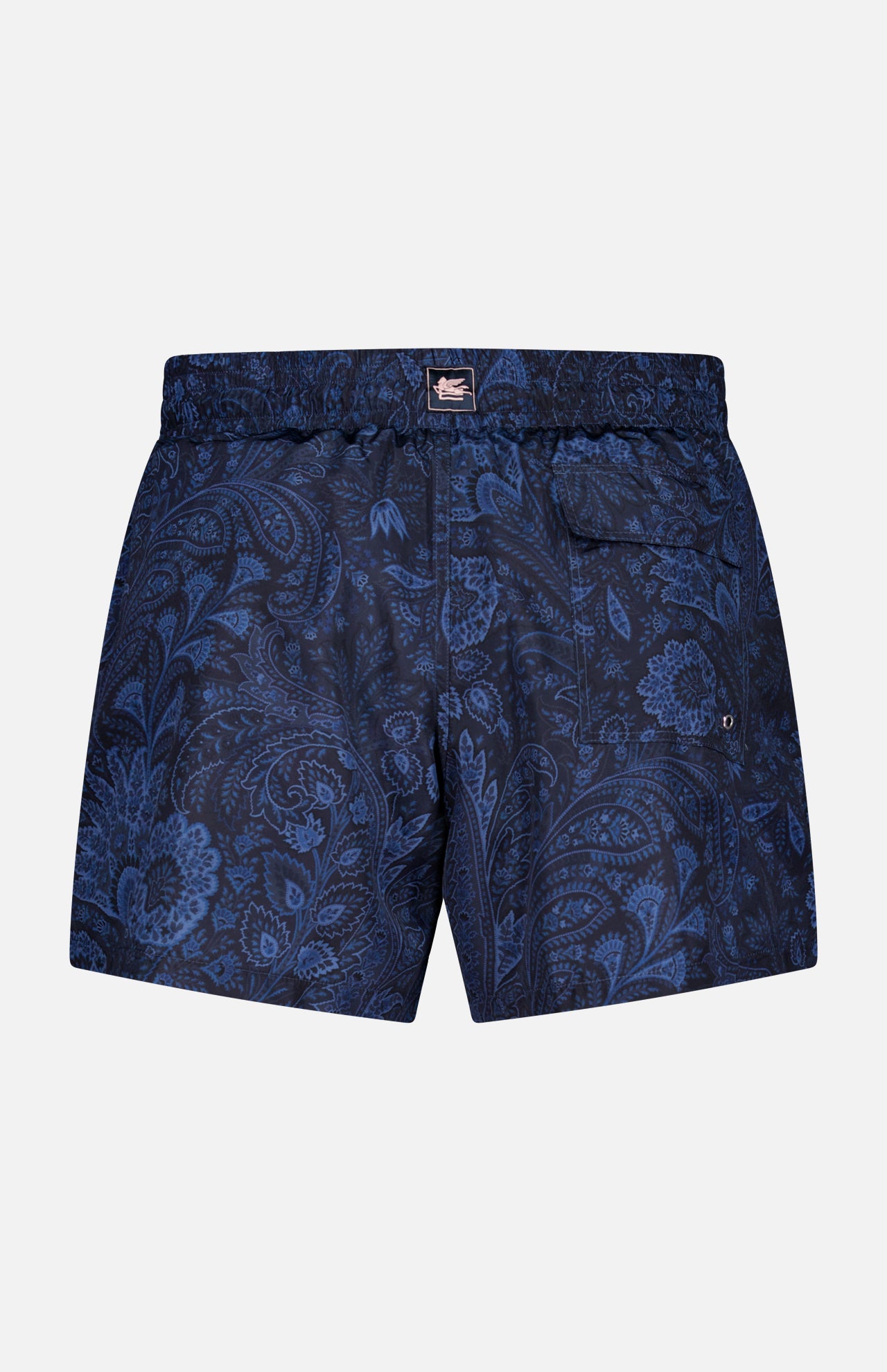 Back view of ETRO Paisley Print Swim Trunk: navy men's swimwear with light blue paisley pattern, elastic waistband, and a single buttoned back pocket.
