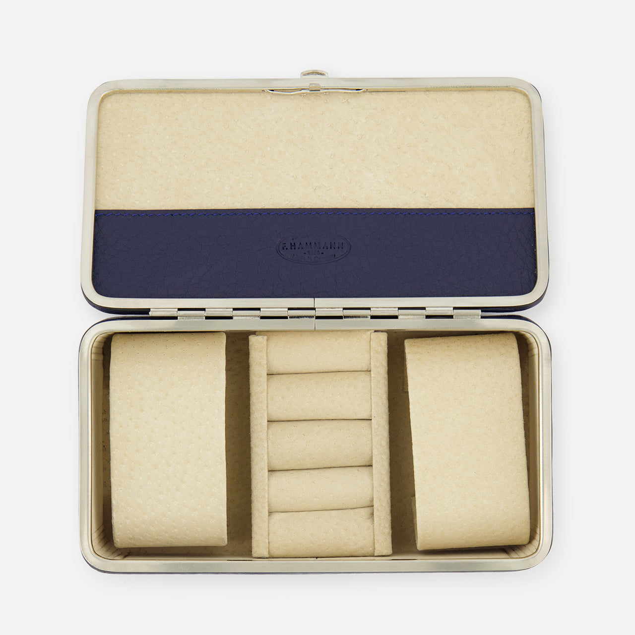 The F. HAMMANN Cowhide Jewelry Box is a rectangular, open leather case with a beige padded interior, two large side compartments, five central ring slots, and a blue accent on the lid—ideal as a travel case for your valuables.
