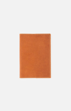 The F. HAMMANN Cowhide Passport Holder is a closed, light brown leather accessory with visible edge stitching, shown on a plain white background. Made in Germany, it's an elegant choice for travel.