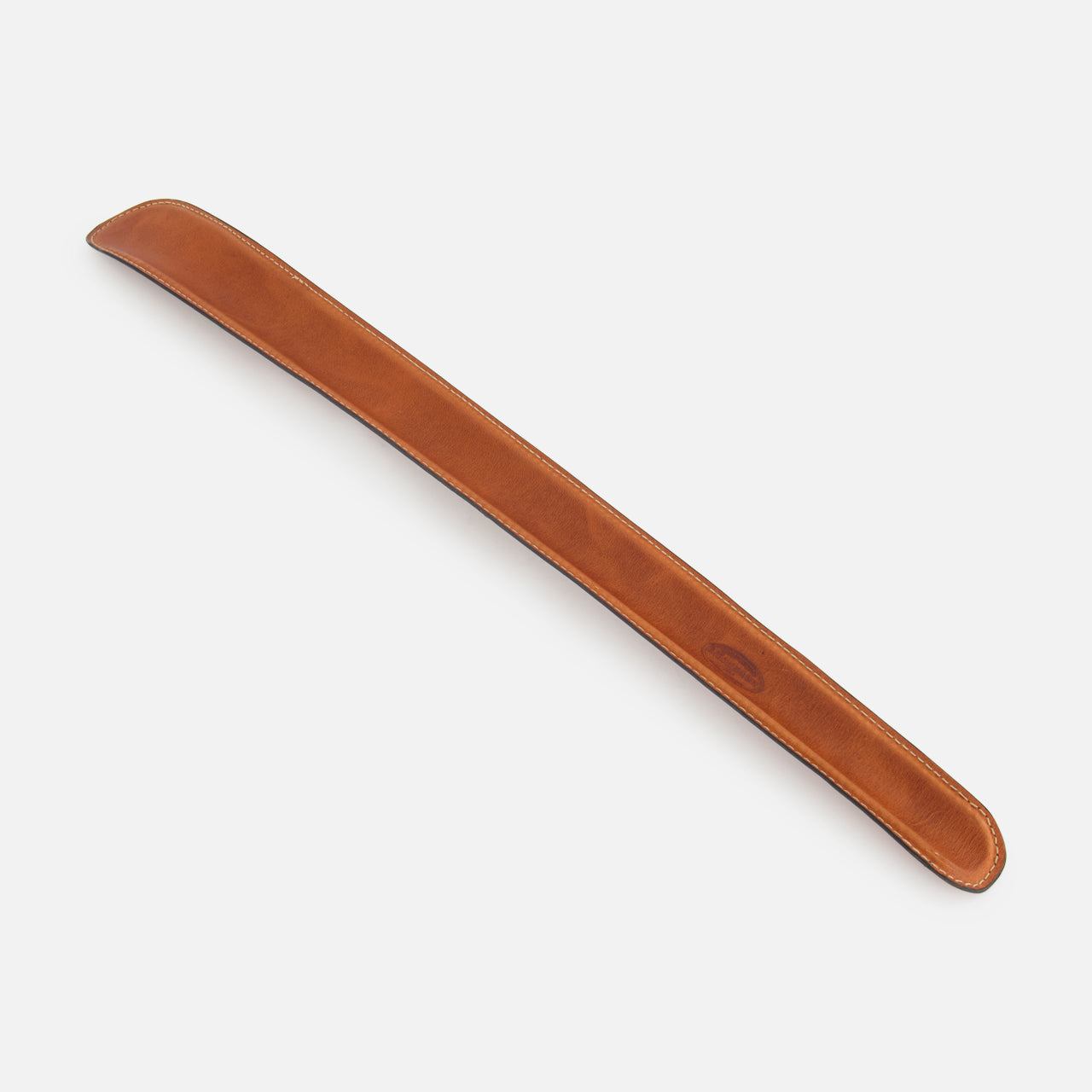 The F. HAMMANN Cowhide Shoehorn is a long, brown leather accessory with rounded edges, designed for luxury footwear and shown on a white background.
