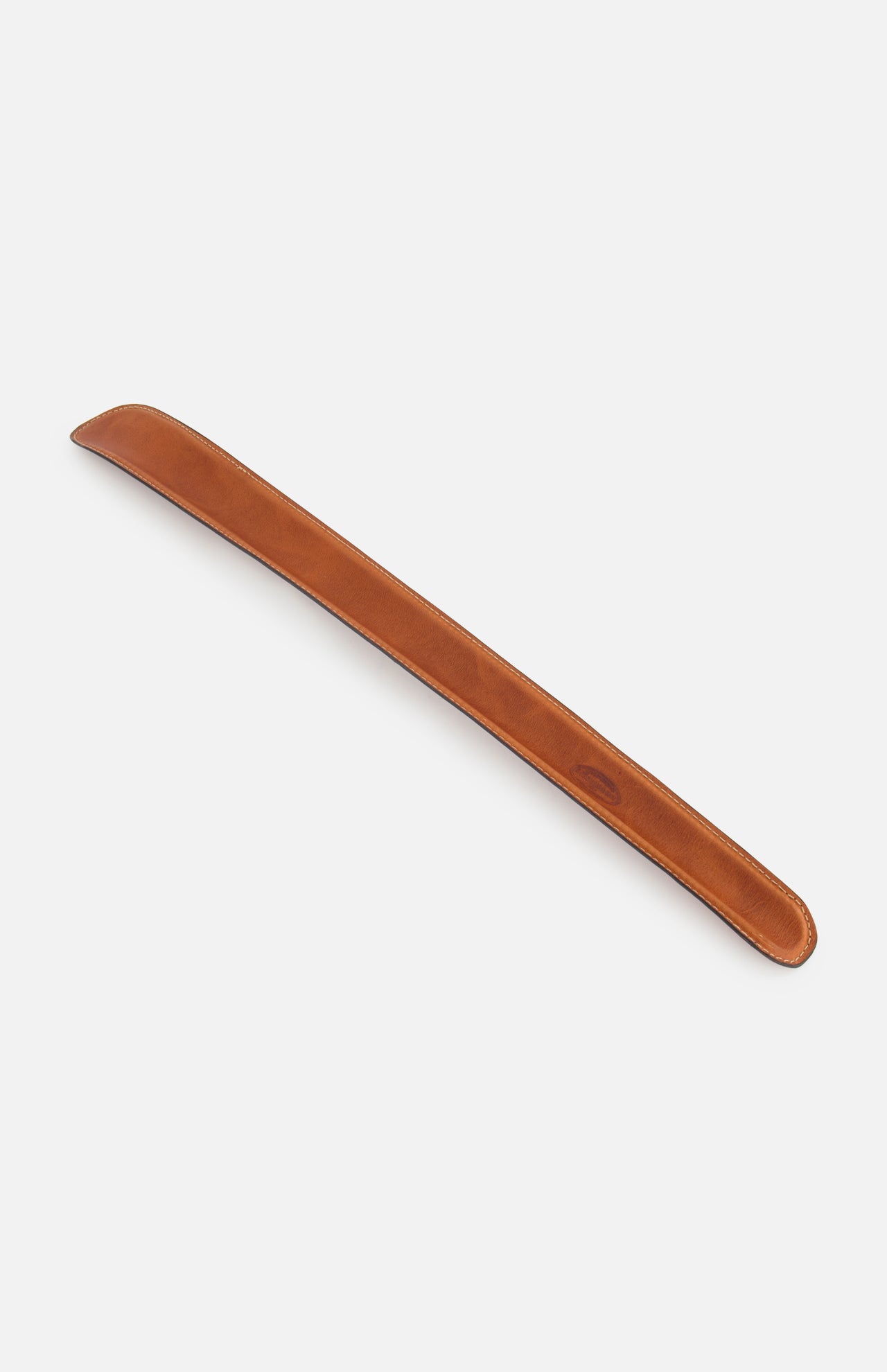 The F. HAMMANN Cowhide Shoehorn is a long, brown leather accessory with rounded edges, designed for luxury footwear and shown on a white background.