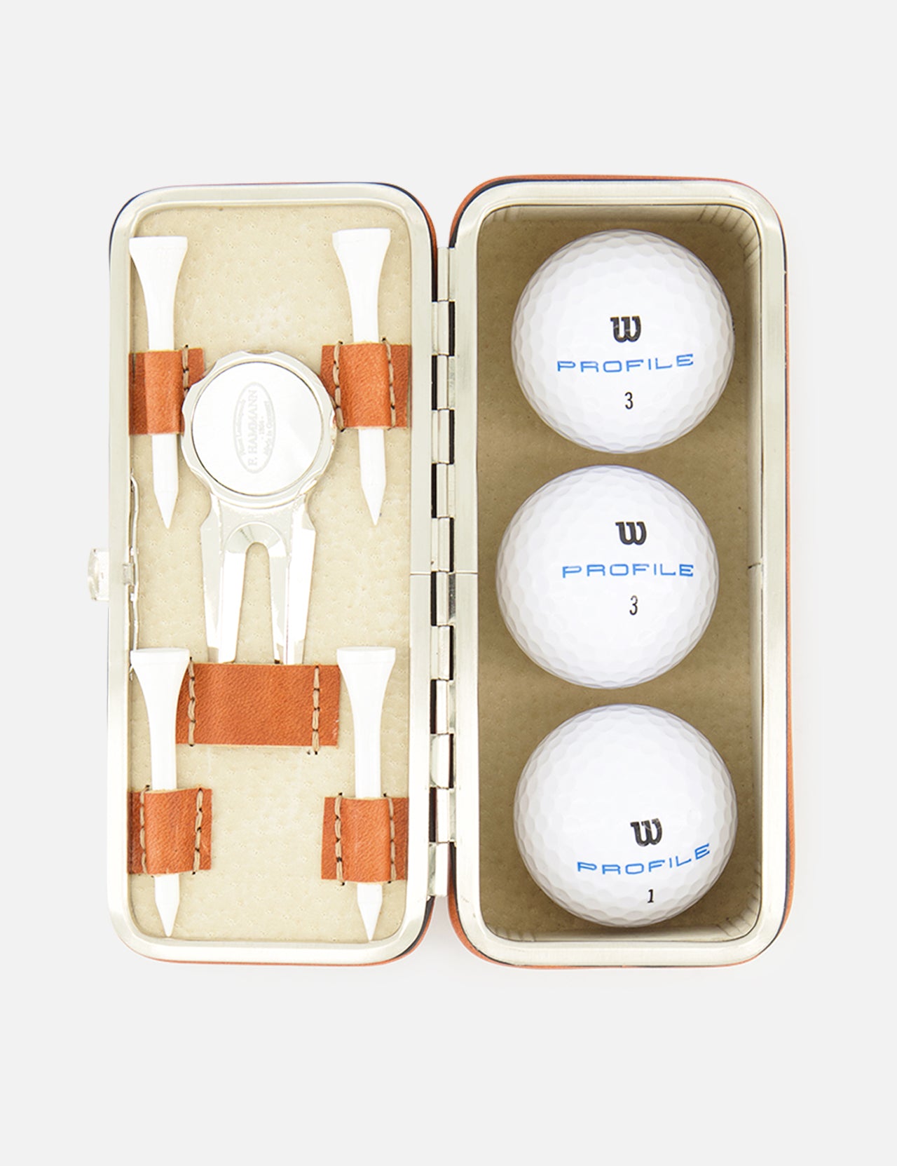 The F. HAMMANN Cowhide Golf Set, made in Germany, features a leather case with three white Wilson Profile balls, four wooden tees, a divot tool, and a ball marker, all organized in fitted compartments.