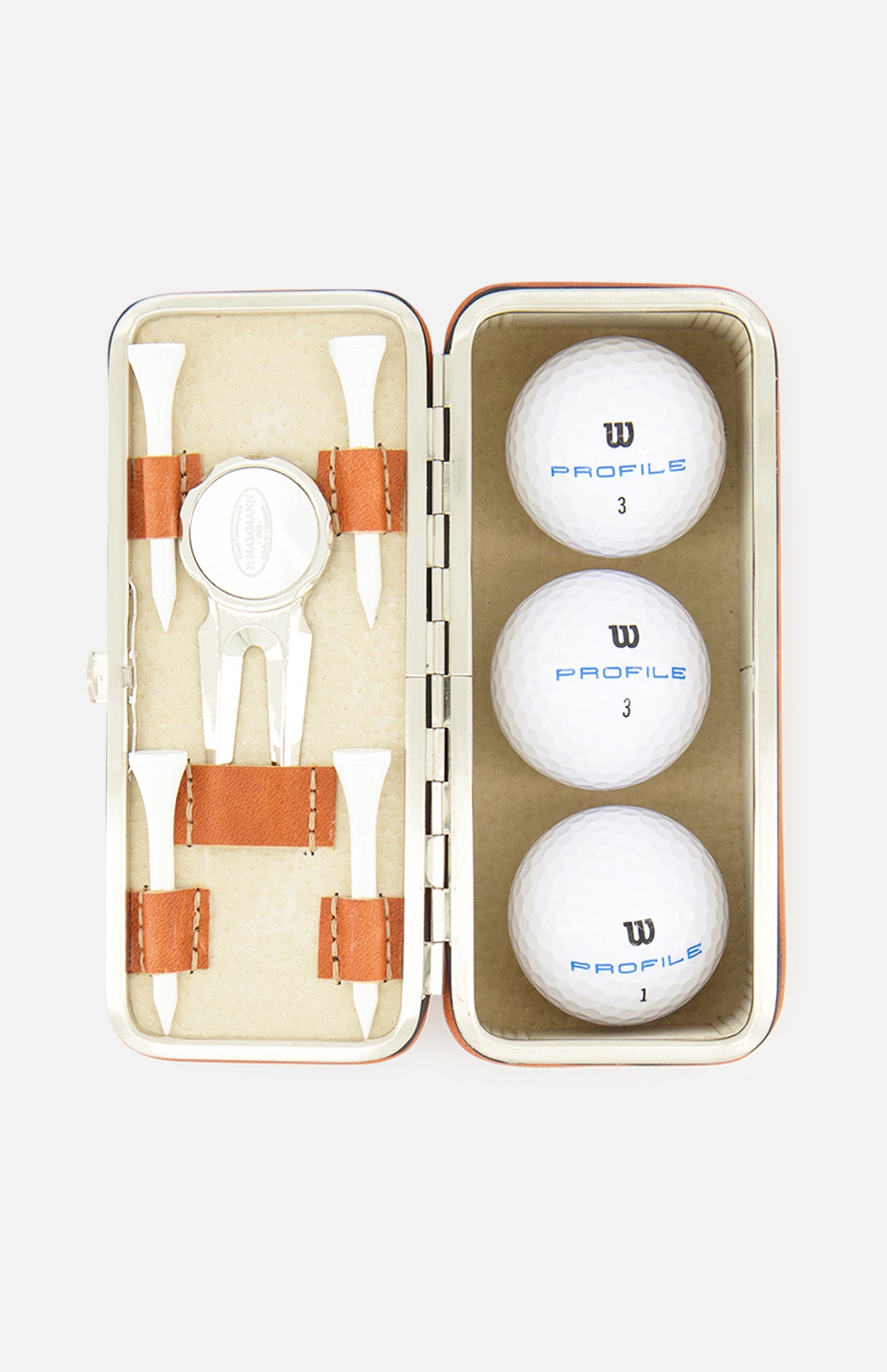 The F. HAMMANN Cowhide Golf Set, made in Germany, features a leather case with three white Wilson Profile balls, four wooden tees, a divot tool, and a ball marker, all organized in fitted compartments.