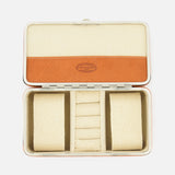 The F. HAMMANN Cowhide Jewelry Box is a rectangular, open leather case with a beige and tan interior, two cushioned side compartments, and a center section with four ring slots—an elegant travel jewelry organizer.
