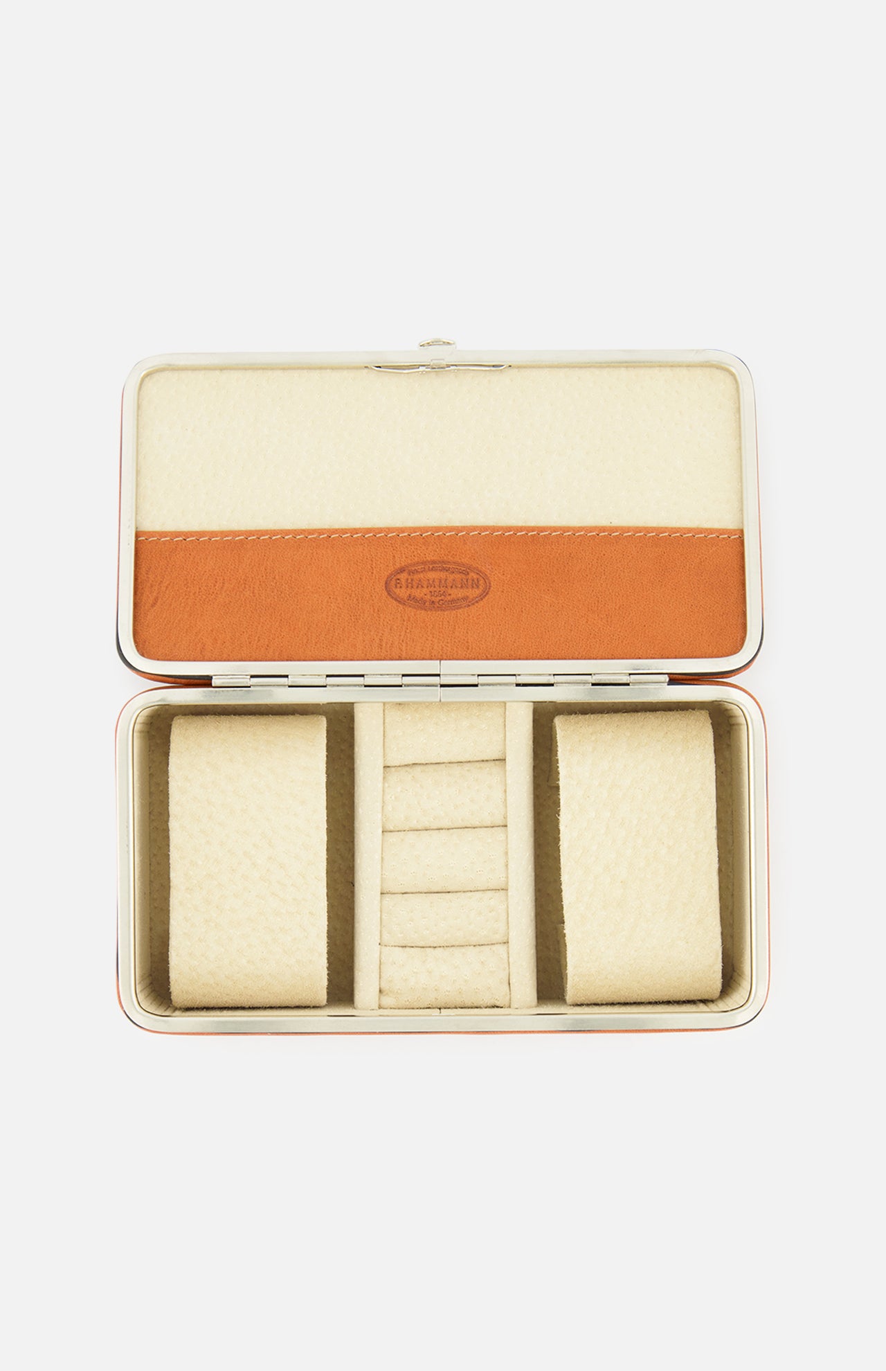 The F. HAMMANN Cowhide Jewelry Box is a rectangular, open leather case with a beige and tan interior, two cushioned side compartments, and a center section with four ring slots—an elegant travel jewelry organizer.