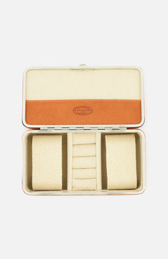 The F. HAMMANN Cowhide Jewelry Box is a rectangular, open leather case with a beige and tan interior, two cushioned side compartments, and a center section with four ring slots—an elegant travel jewelry organizer.
