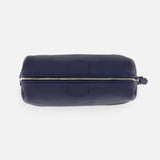 The Mousetrap Flat Toiletry Bag by F. HAMMANN is shown from above in navy blue leather, featuring a silver zipper along the top with a small pull tab—an elegant travel accessory.