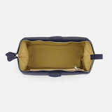 The Mousetrap Flat Toiletry Bag by F. HAMMANN features a rectangular navy blue leather exterior, a spacious tan interior lining, and an inner side pocket—making it a stylish travel accessory.