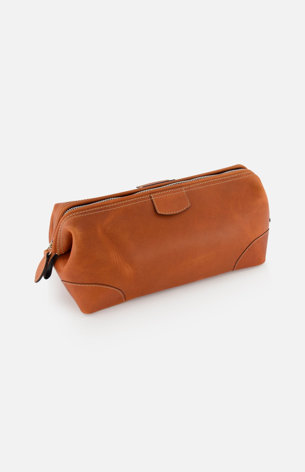 The Mousetrap Flat Toiletry Bag by F. HAMMANN is a brown leather, rectangular travel accessory with rounded corners and visible stitching, shown against a white background.