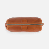 A top-down view of The Mousetrap Flat Toiletry Bag by F. HAMMANN, featuring brown leather, visible stitching, and a zippered closure on a white background—a stylish and durable travel accessory.