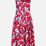 The Cherry Blossom Sleeveless Midi Dress by FARM RIO features thin straps, a fitted bodice, flared skirt, sweetheart neckline, and bold red cherry with green leaf print on white.