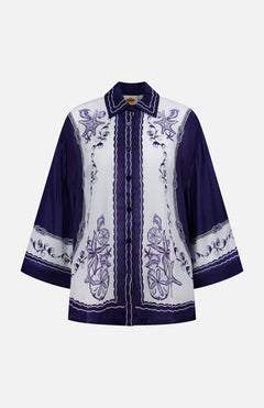 The Coast Scarf Wide Sleeve Shirt by FARM RIO is a long-sleeve, button-up with a white base, detailed purple floral and fruit embroidery, and bold purple sleeves—perfect for making a statement on vacation.