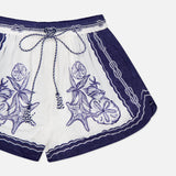 The Coast Scarf Shorts by FARM RIO feature a relaxed fit, drawstring waist, and intricate purple and blue floral and sea star embroidery—perfect for your next coastal vacation.
