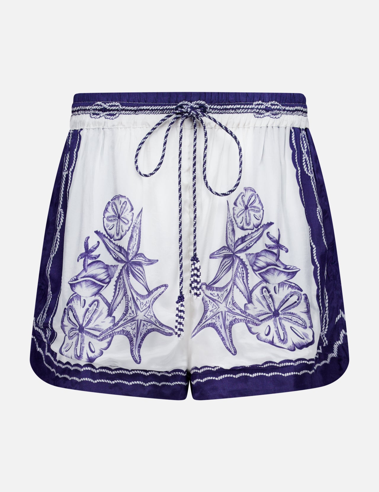 The Coast Scarf Shorts by FARM RIO are white coastal vacation shorts with a navy waistband, blue floral and leaf embroidery on the front, borders, and a braided drawstring tie at the waist.