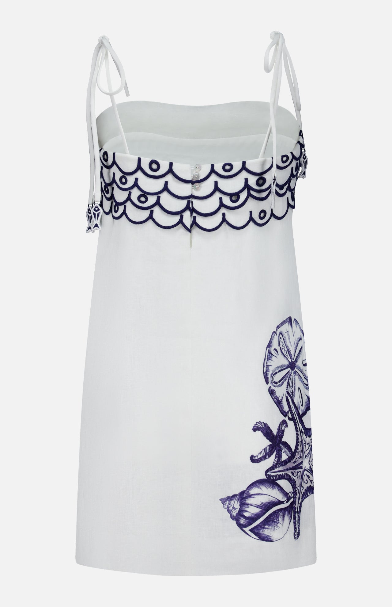 The Coast Stars Linen Mini Dress by FARM RIO is a white sleeveless summer dress with thin shoulder ties, scalloped navy embroidery on top, and navy sea life with starfish and shells—perfect for any coastal party.